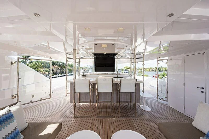 a large white room with a table and chairs aboard SEANASH Yacht for Sale