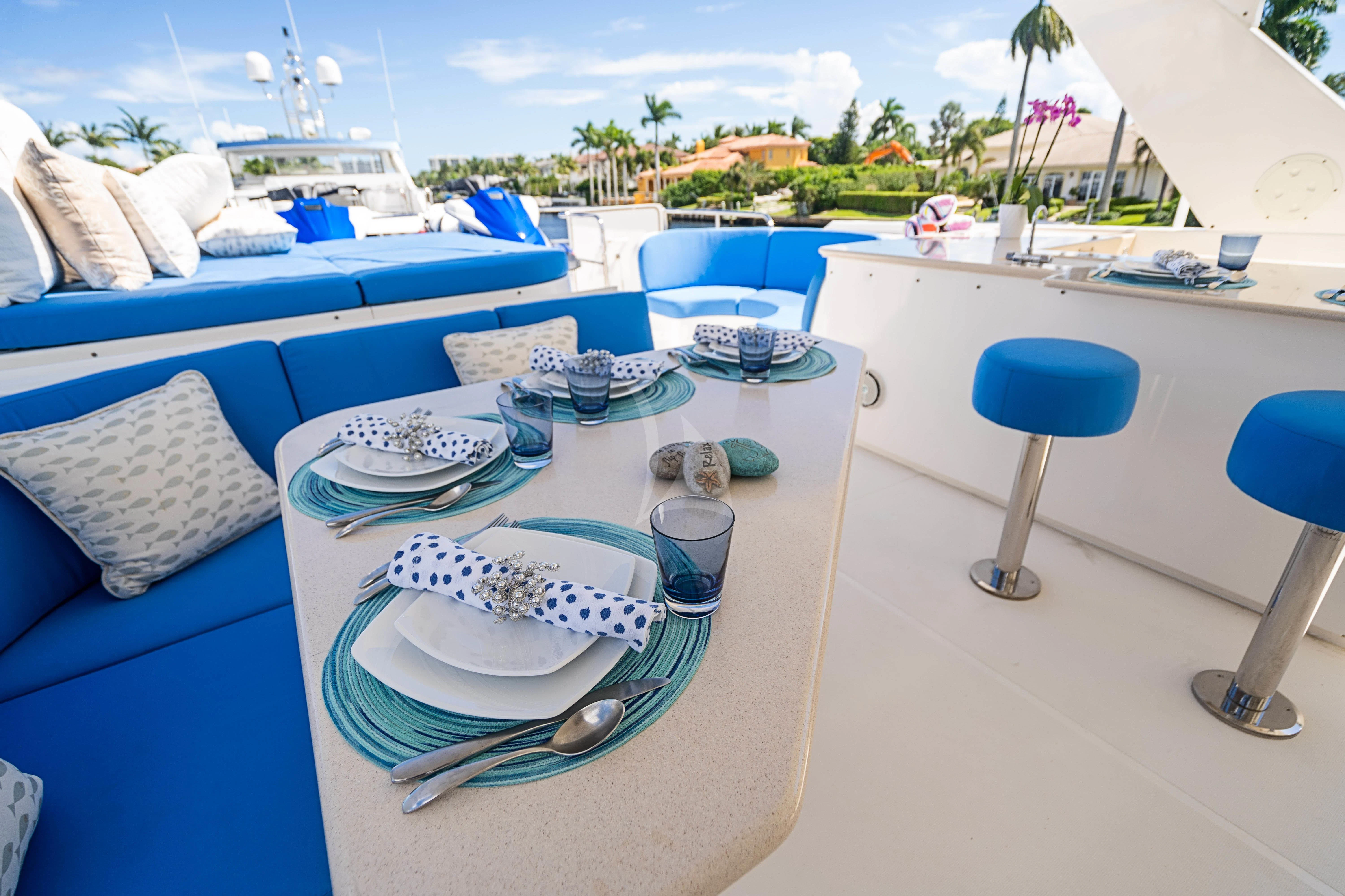 a table with plates and cups on it aboard BOOGIE BABE IV Yacht for Sale