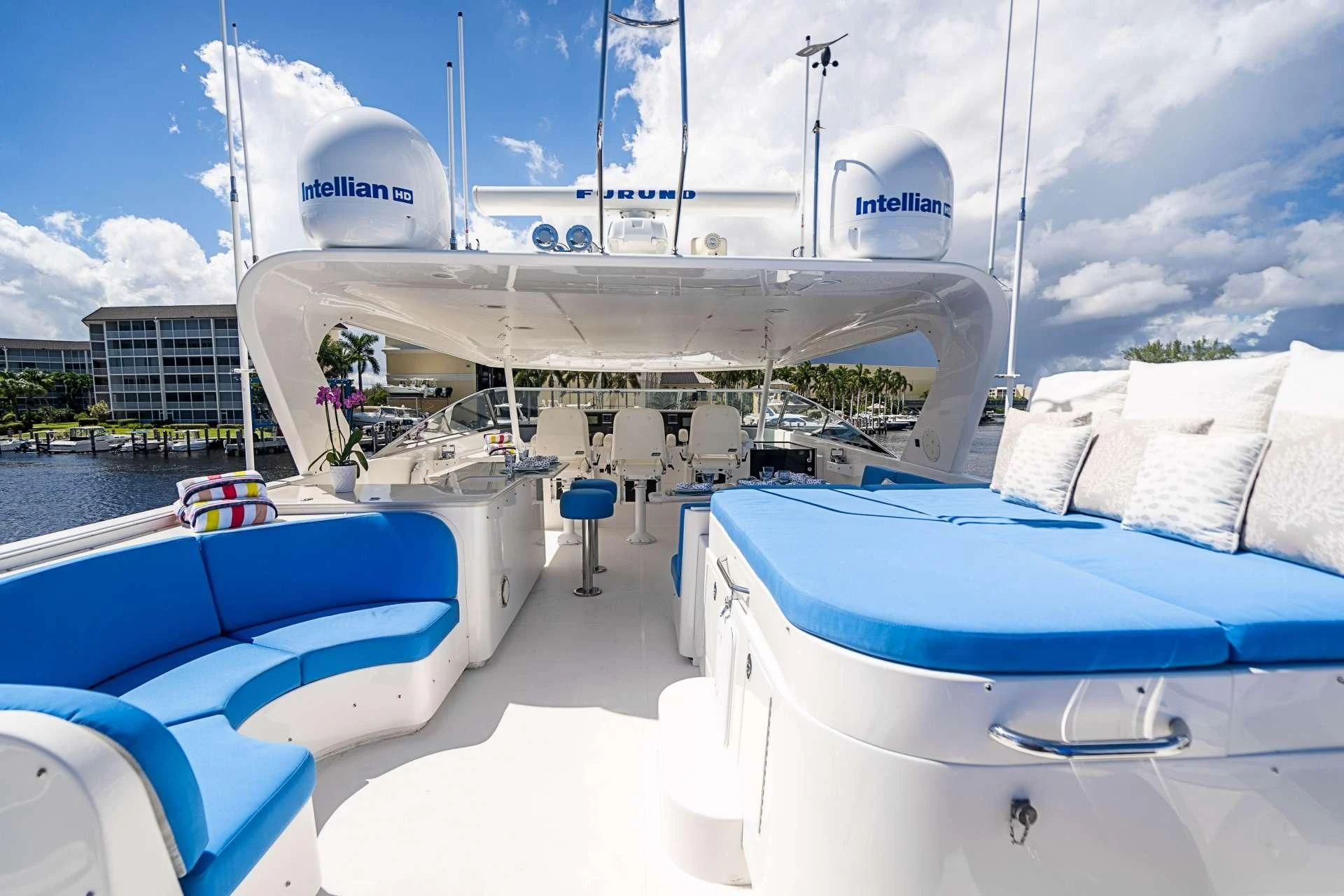 a white boat on a dock aboard BOOGIE BABE IV Yacht for Sale
