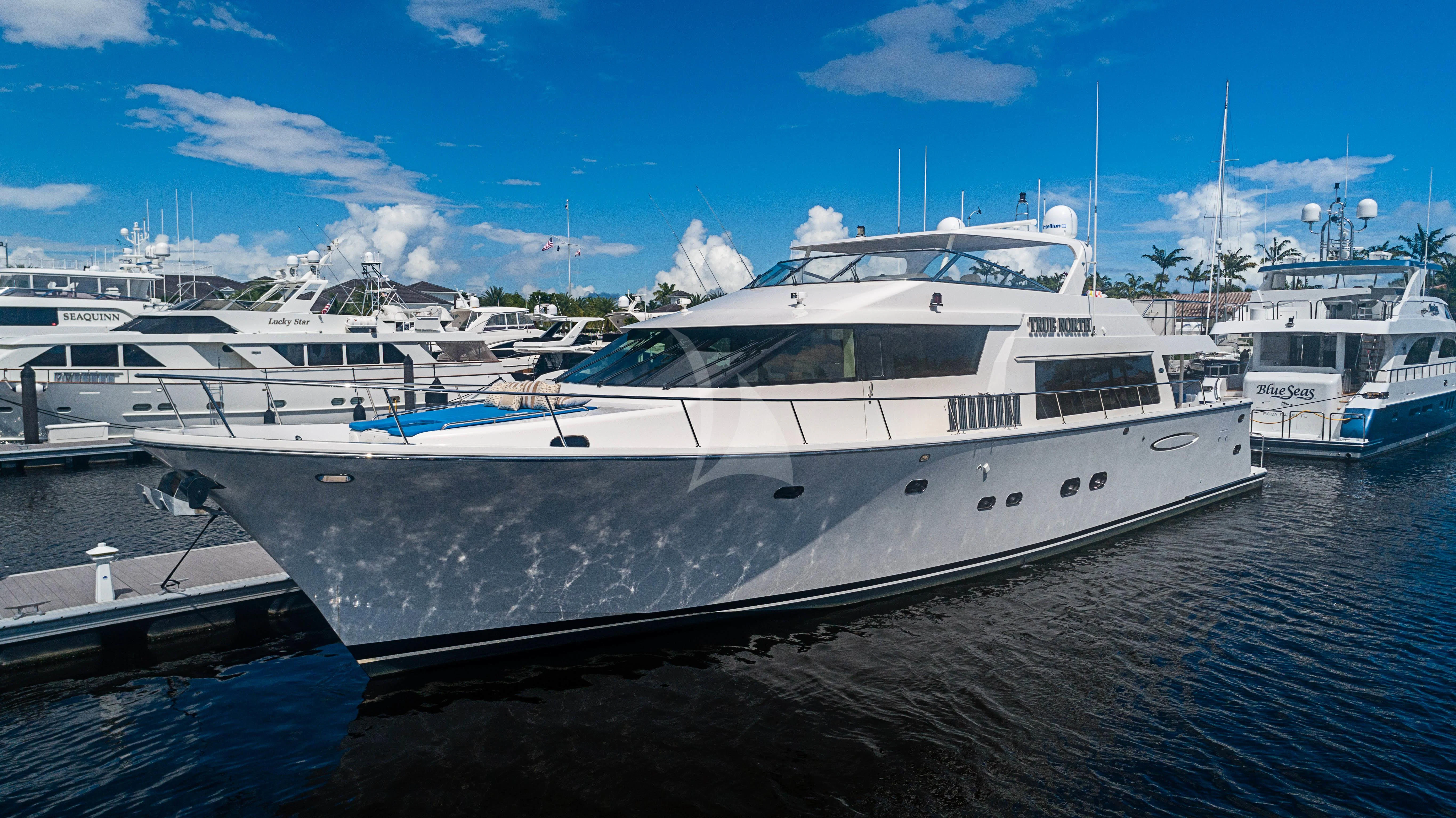 a boat docked at a pier aboard BOOGIE BABE IV Yacht for Sale