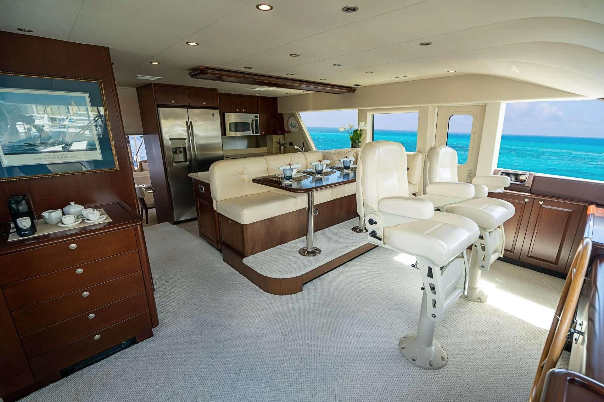 a room with a desk and chairs aboard BOOGIE BABE IV Yacht for Sale