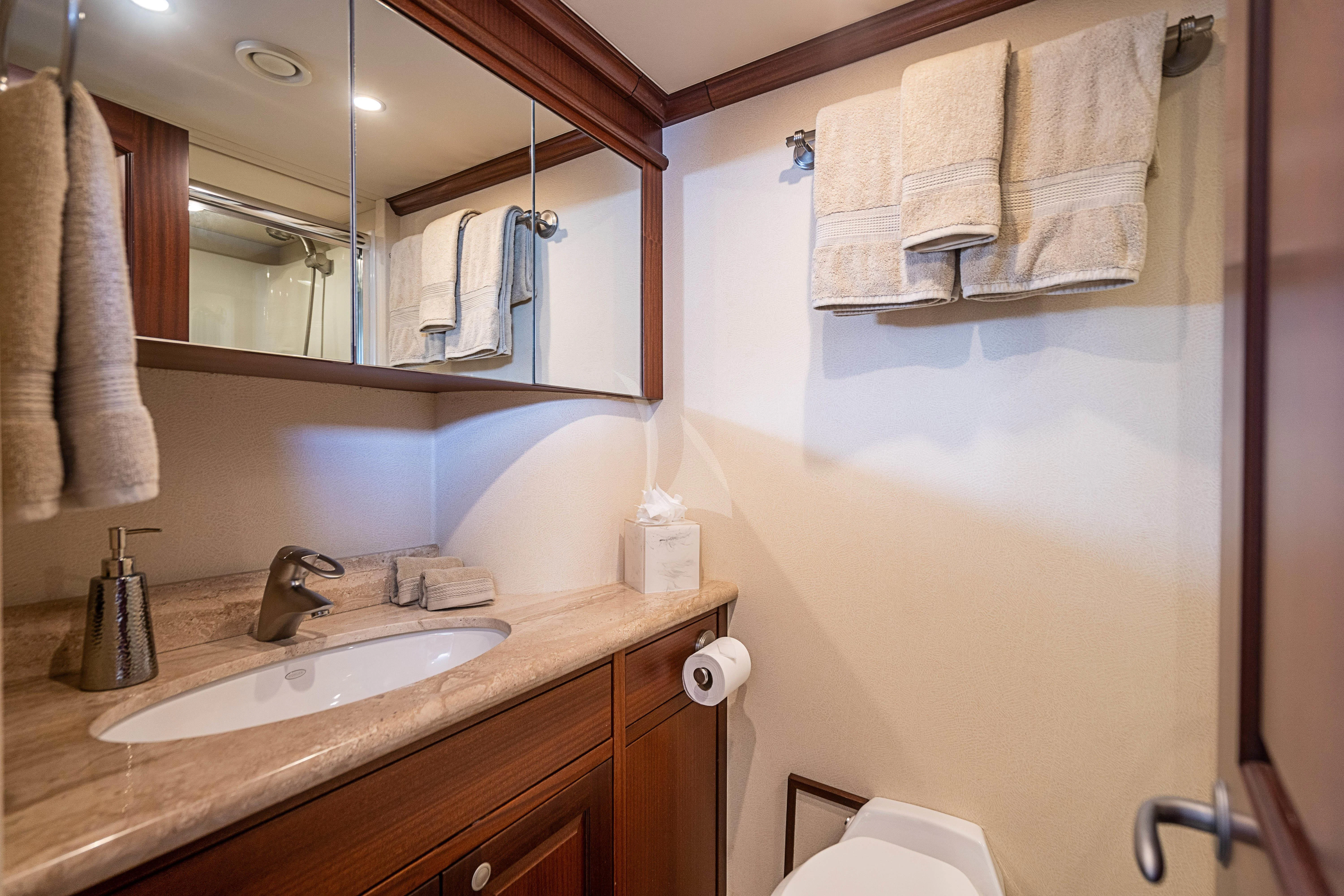 a bathroom with a sink and towels aboard BOOGIE BABE IV Yacht for Sale
