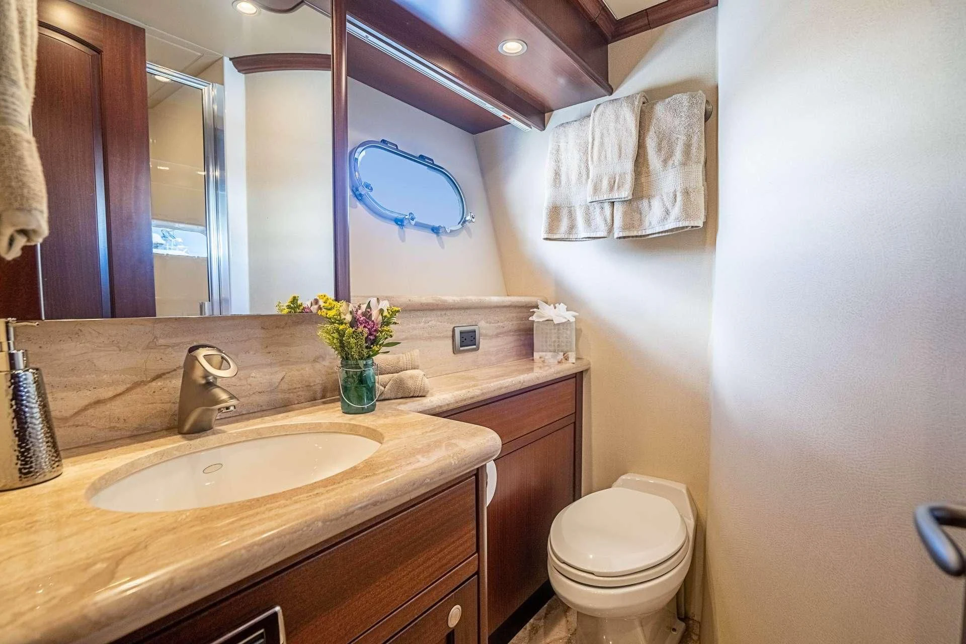 a bathroom with a sink toilet and a mirror aboard BOOGIE BABE IV Yacht for Sale
