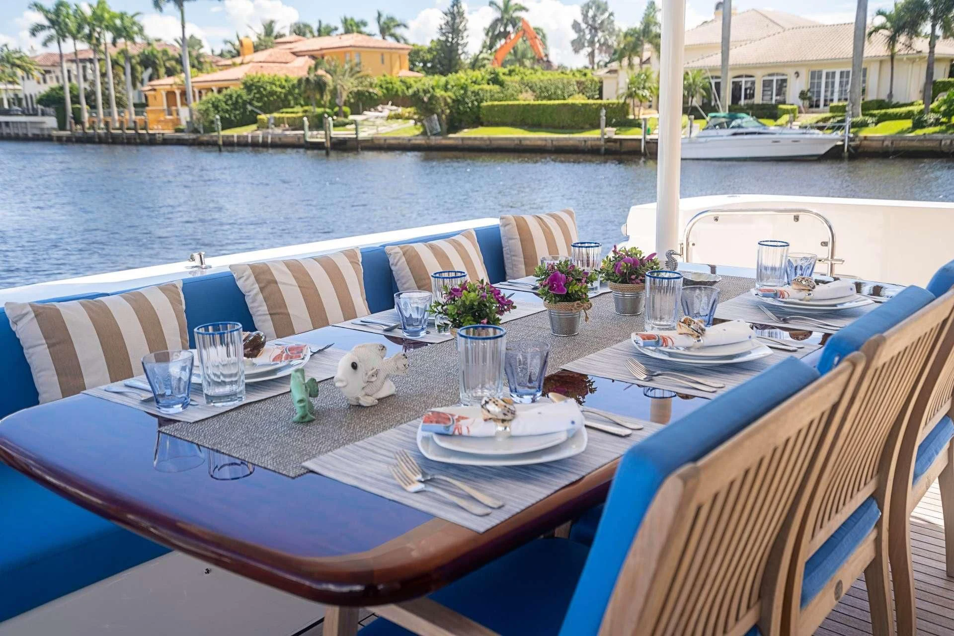 a table with a plate and a glass of water on it aboard BOOGIE BABE IV Yacht for Sale
