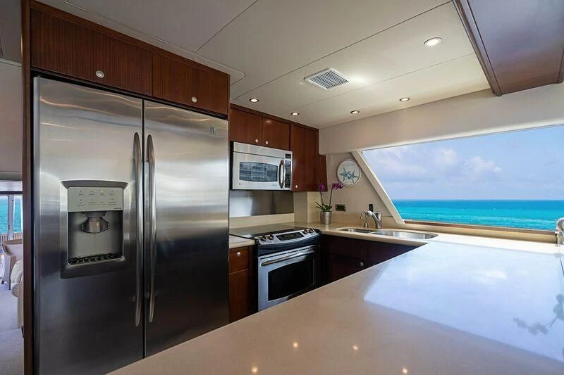 a kitchen with a large refrigerator aboard BOOGIE BABE IV Yacht for Sale