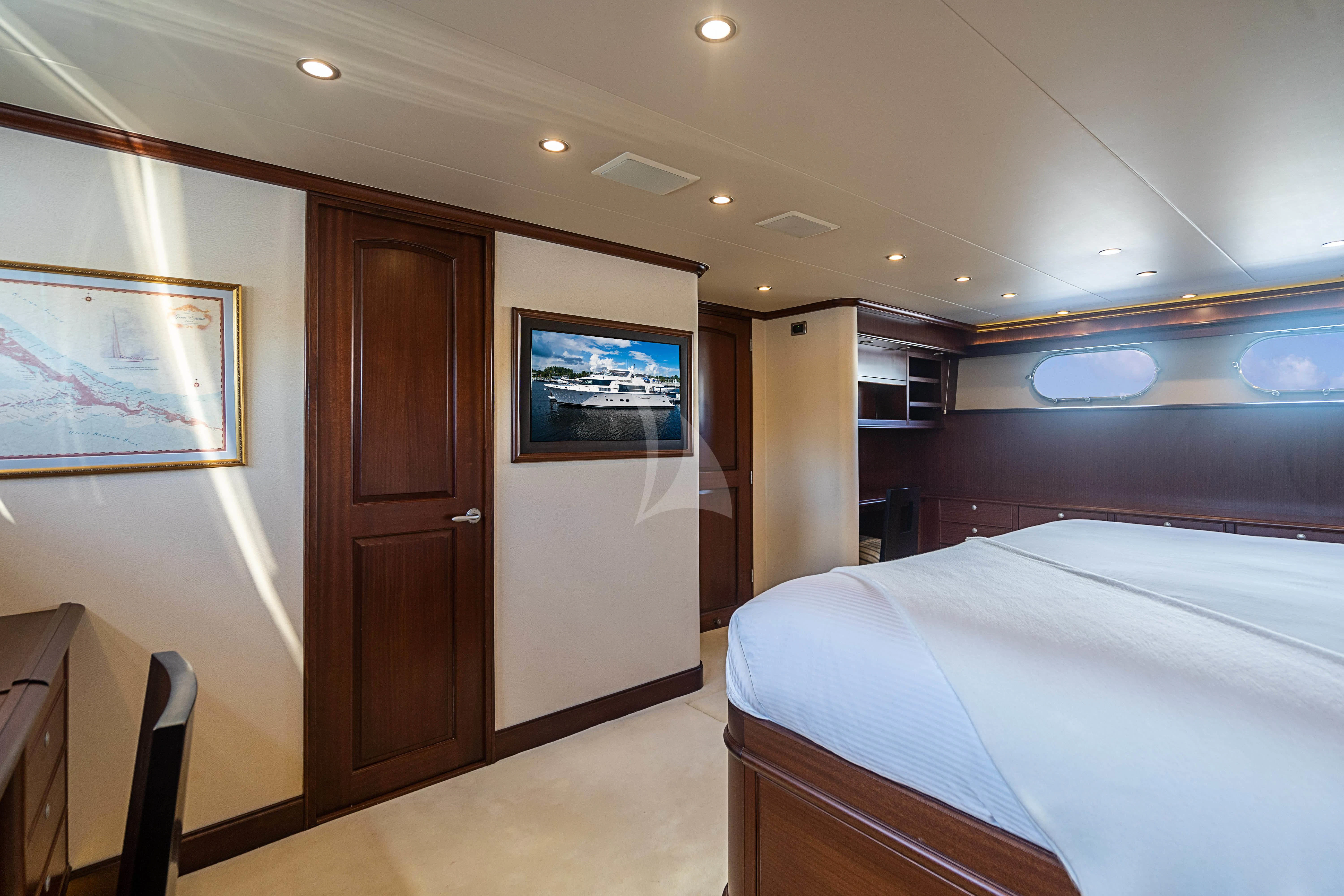 a hotel room with a bed and a door aboard BOOGIE BABE IV Yacht for Sale