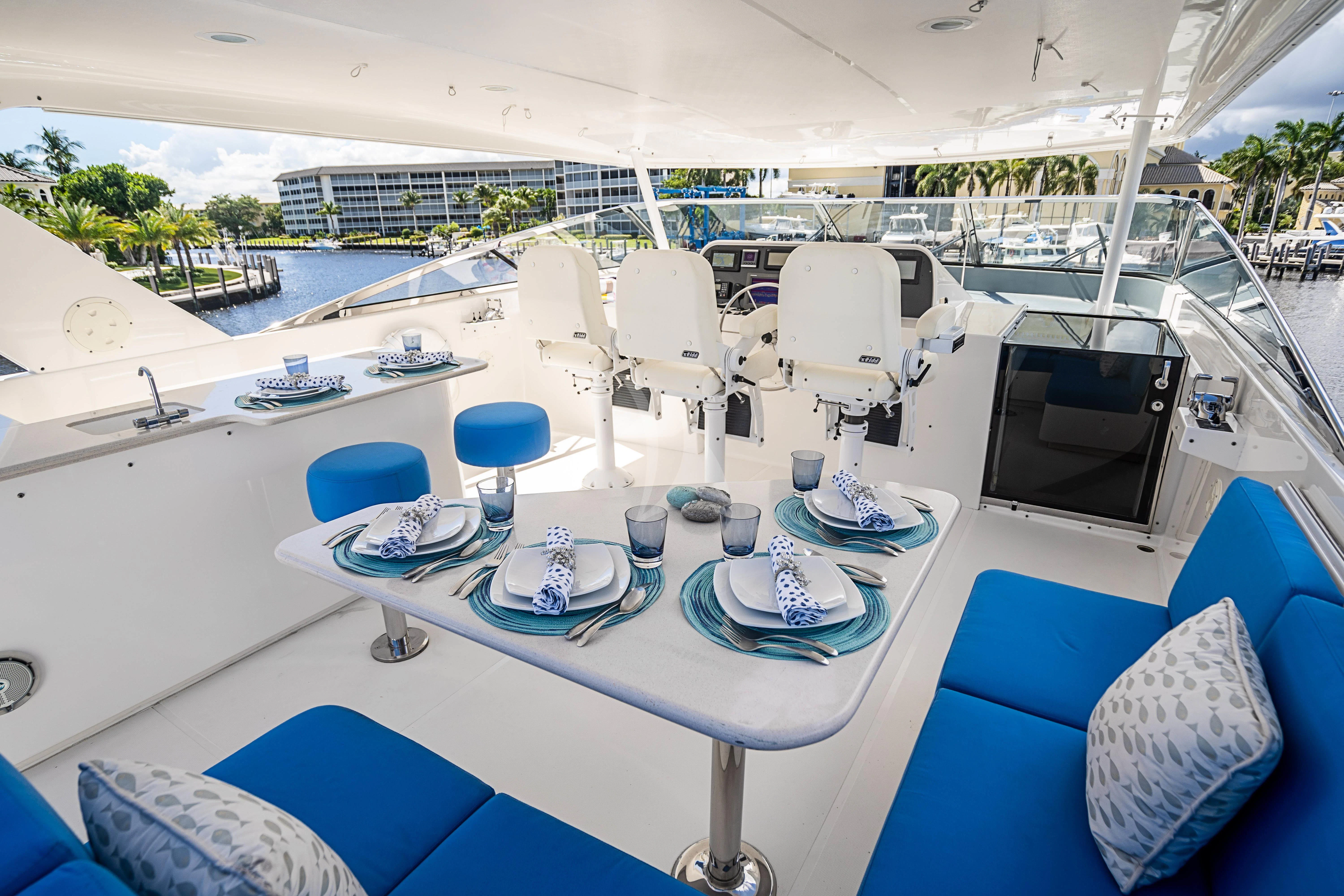 a large lounge area with a pool and lounge chairs aboard BOOGIE BABE IV Yacht for Sale