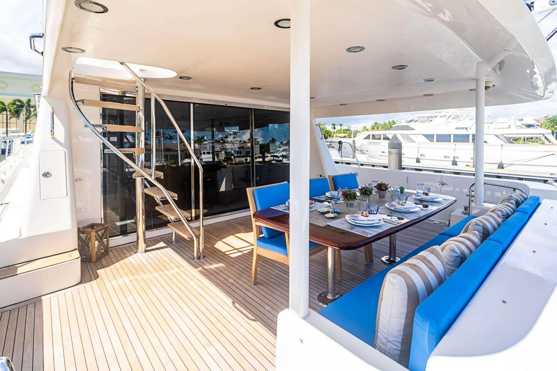 a room with a table and chairs aboard BOOGIE BABE IV Yacht for Sale