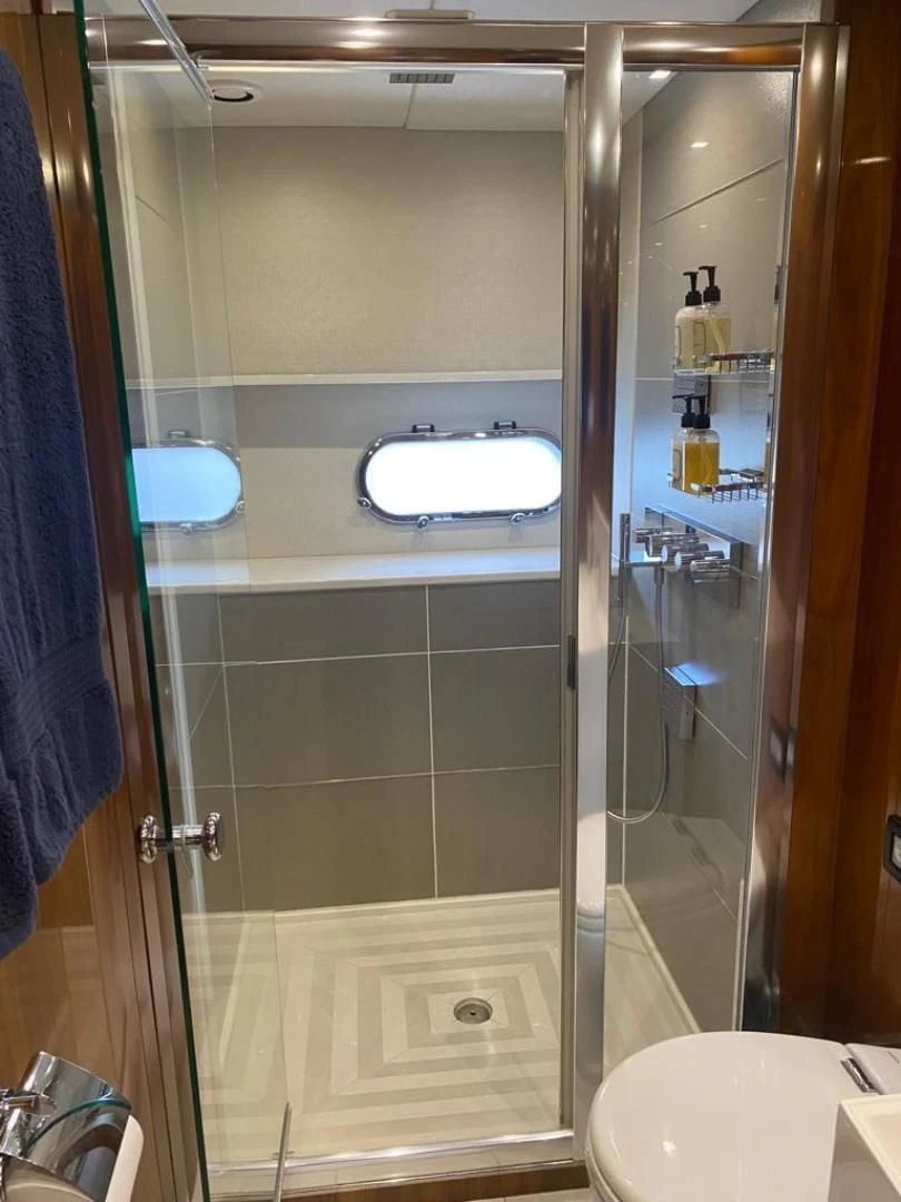 a bathroom with a glass shower aboard RIII Yacht for Sale