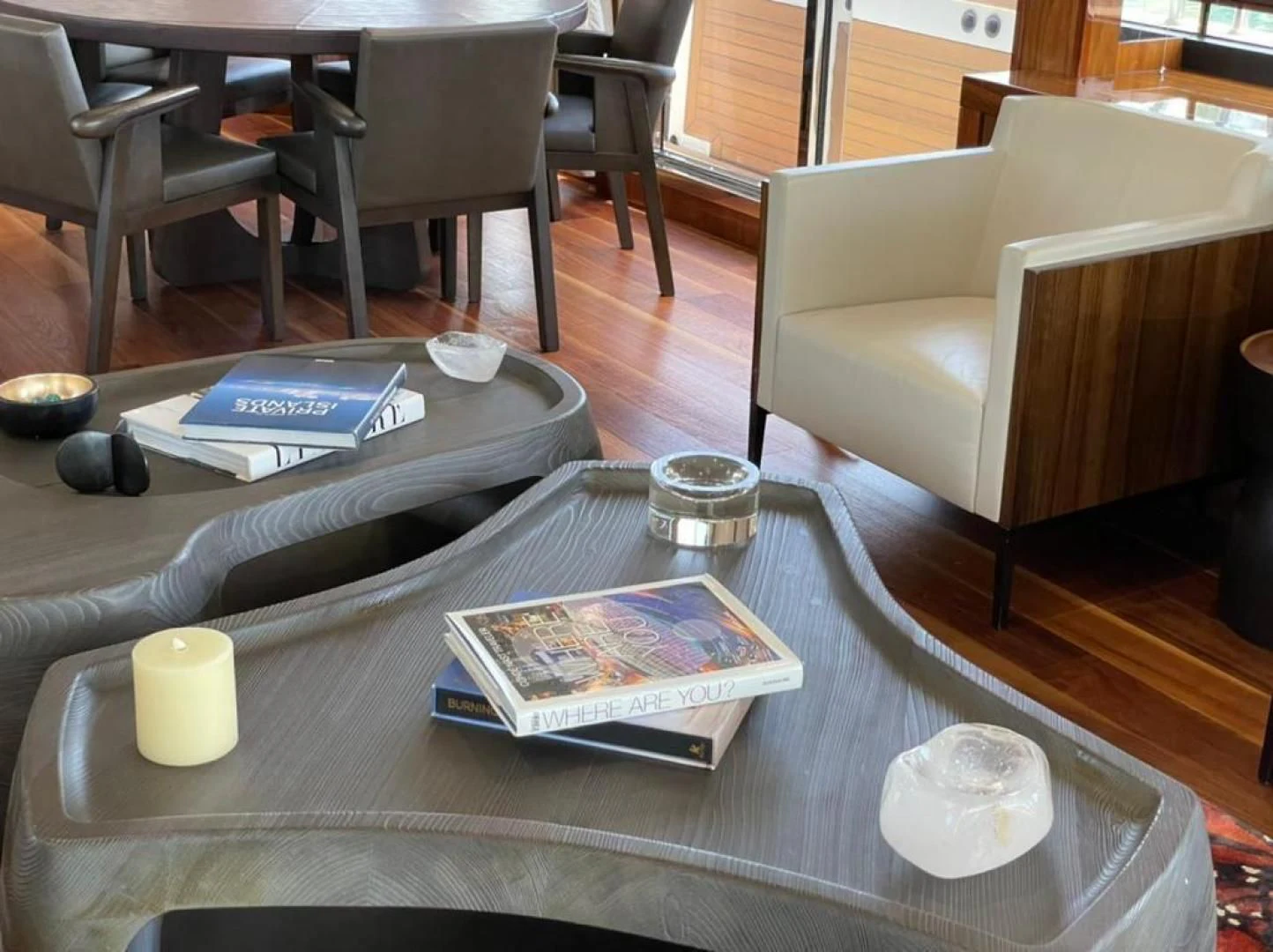 a coffee table with a coffee cup and a book on it aboard RIII Yacht for Sale
