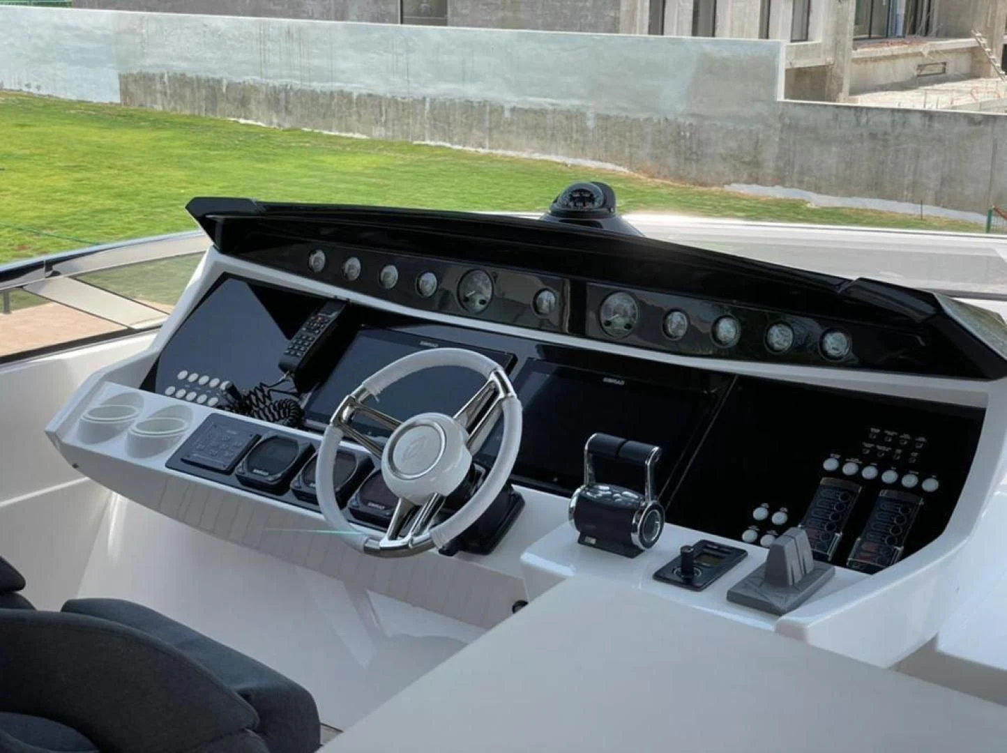 a black console with a white console and a black speaker on the side aboard RIII Yacht for Sale