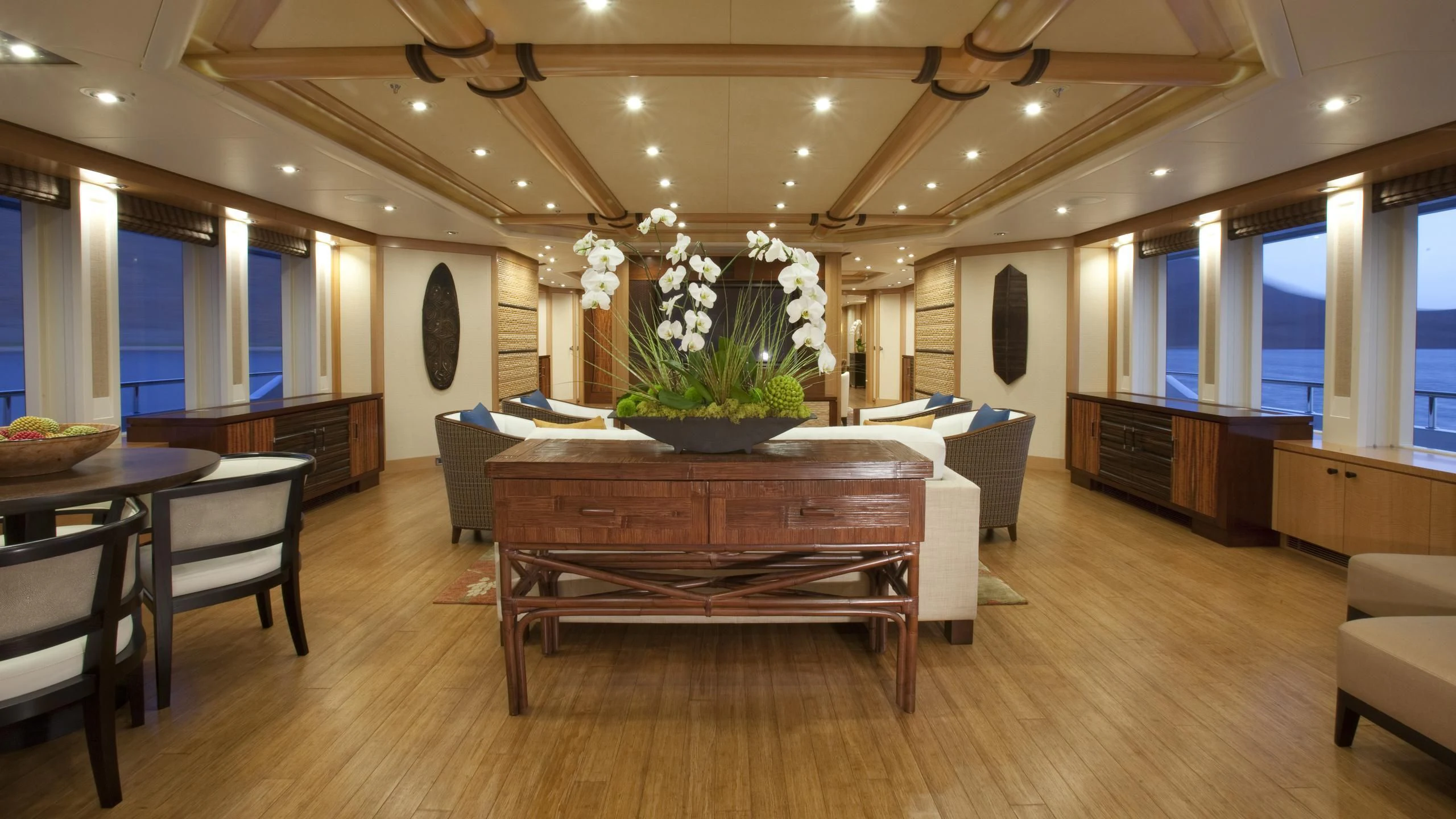 a large room with a table and chairs aboard CHIRON Yacht for Sale