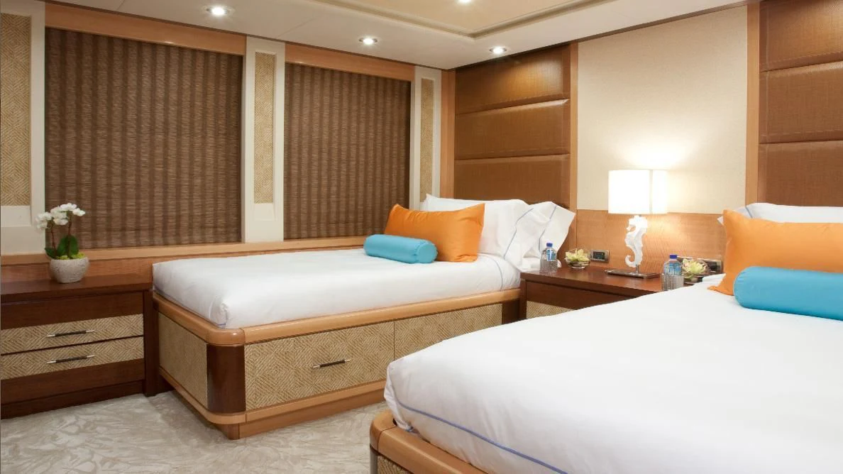 a room with two beds aboard CHIRON Yacht for Sale