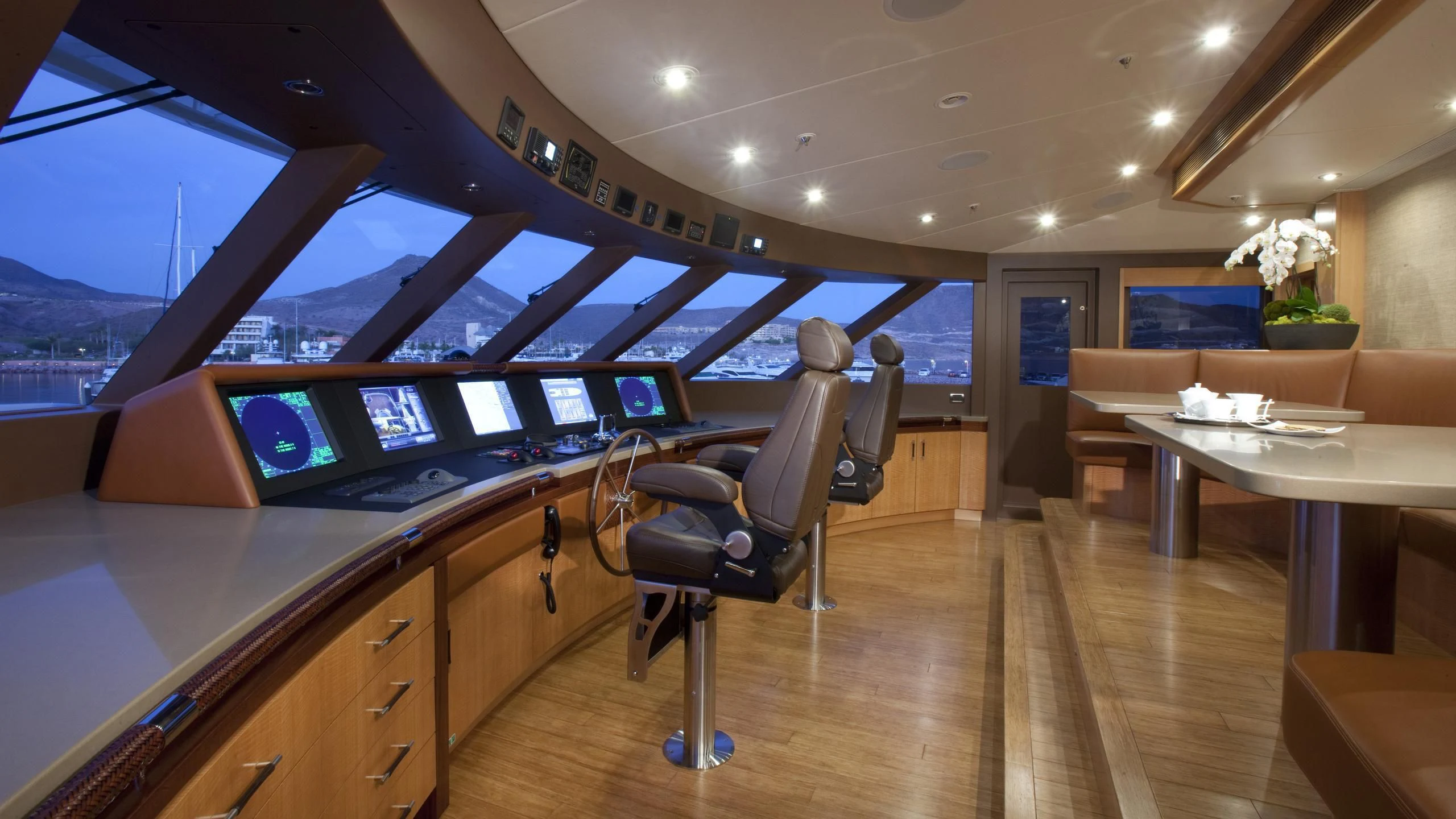 a room with a desk and chairs aboard CHIRON Yacht for Sale