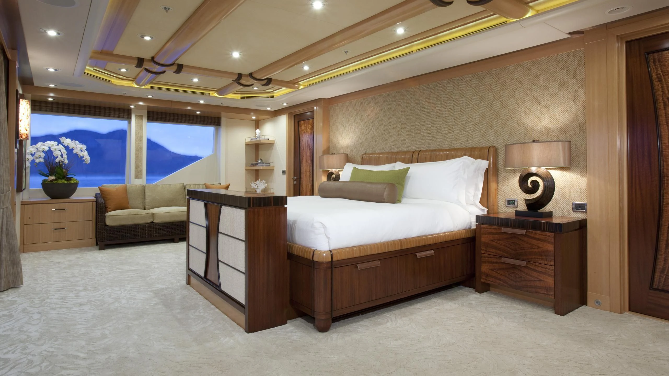 a bedroom with a bed and a desk aboard CHIRON Yacht for Sale
