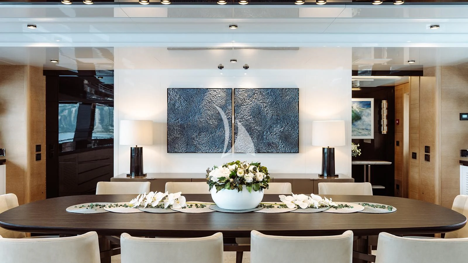 a large room with a table and chairs aboard BON VIVANT Yacht for Sale