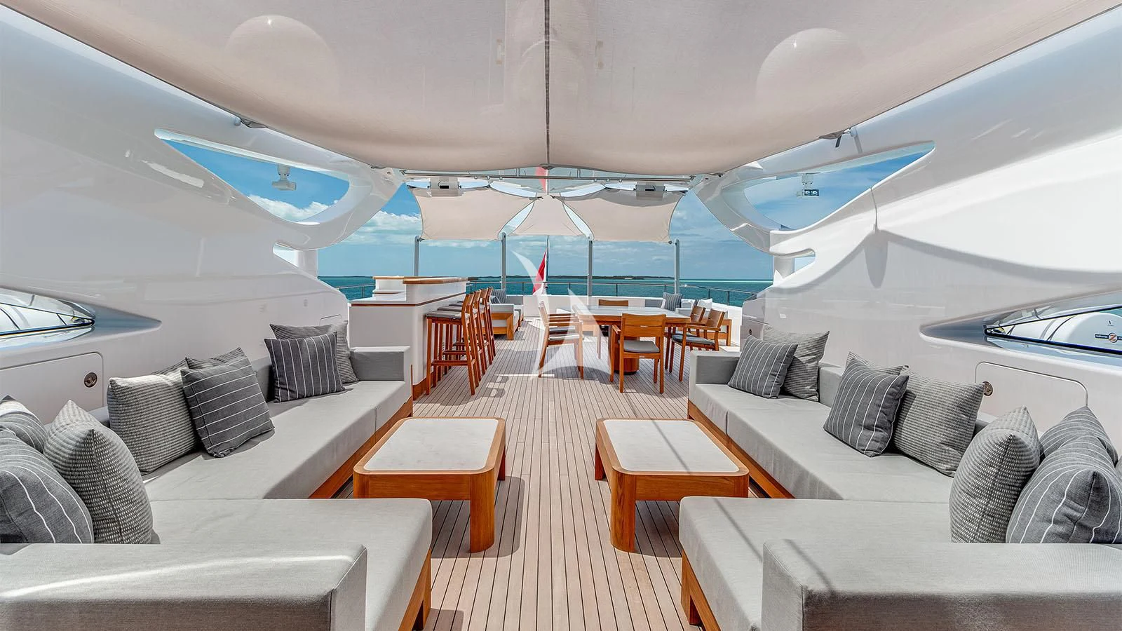 a room with a couch and a table and chairs aboard BON VIVANT Yacht for Sale