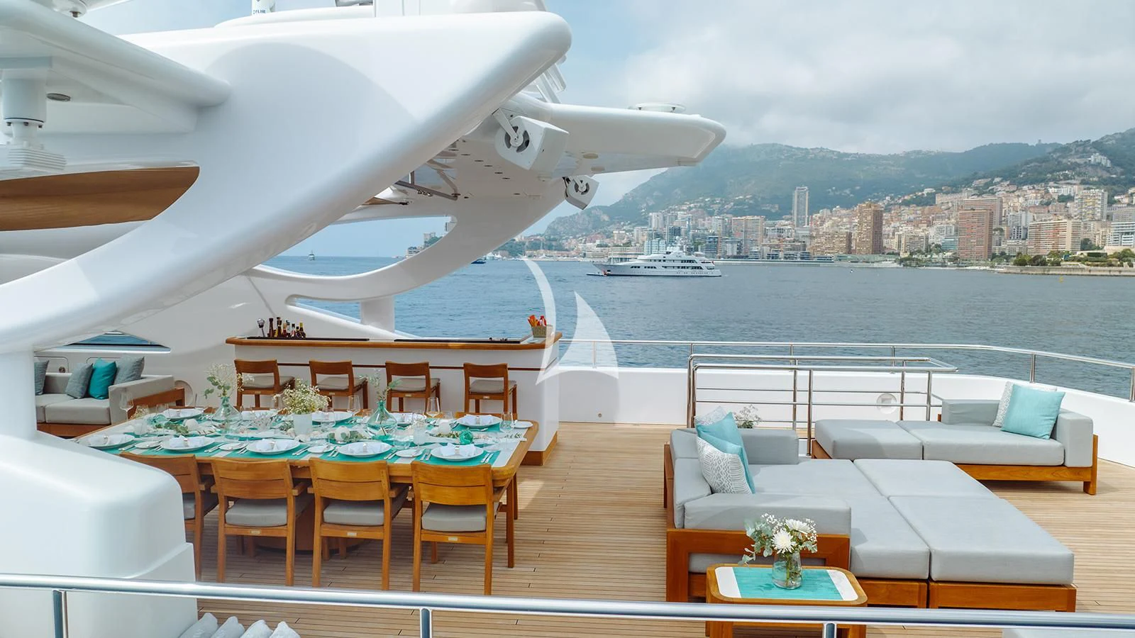 a room with a table and chairs and a plane in the background aboard BON VIVANT Yacht for Sale