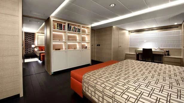 a room with a bed and a bookcase aboard BON VIVANT Yacht for Sale