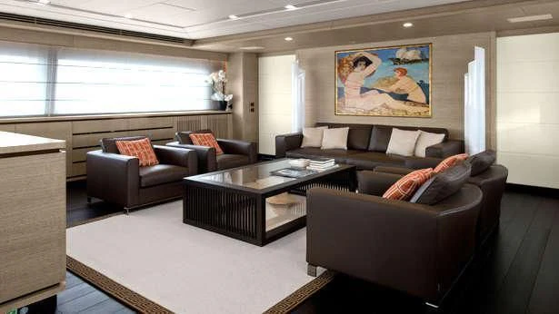 a living room with leather couches and a coffee table aboard BON VIVANT Yacht for Sale
