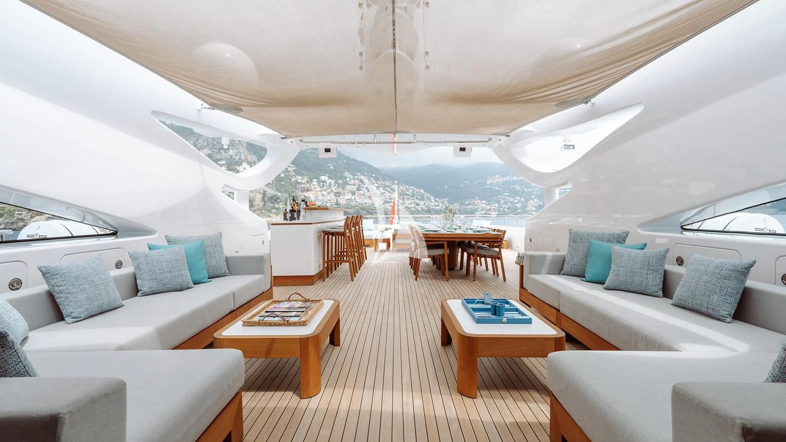 a living room with a large white sofa and a large body of water aboard BON VIVANT Yacht for Sale