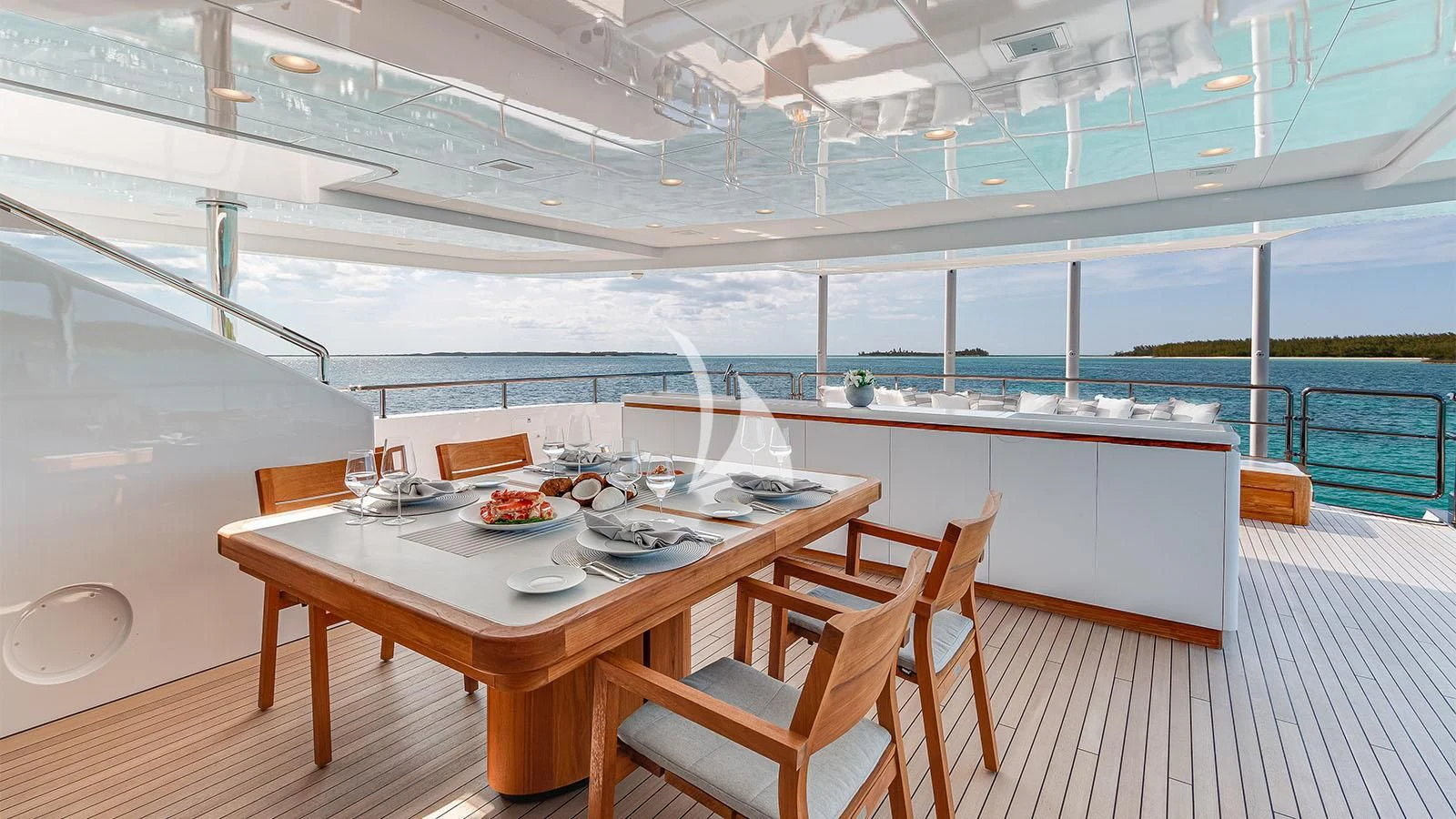 a table with plates and glasses on it aboard BON VIVANT Yacht for Sale