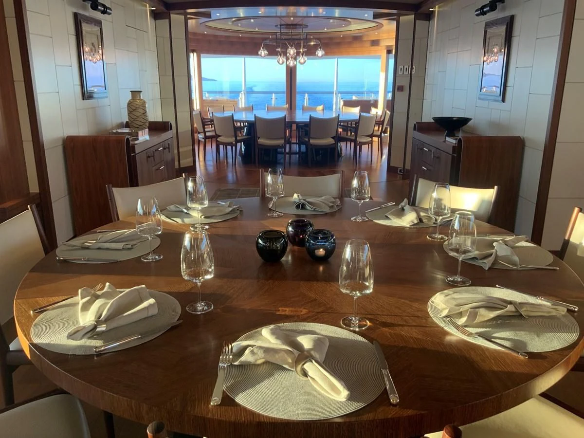 a table with plates and silverware aboard MAN OF STEEL Yacht for Charter