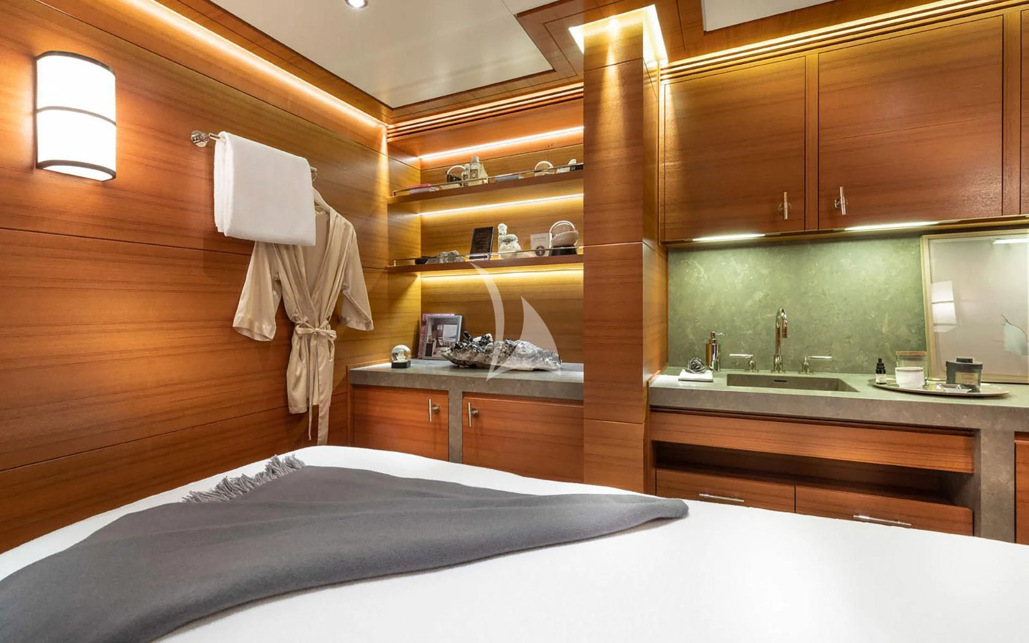a bedroom with a bed and a sink aboard MAN OF STEEL Yacht for Charter
