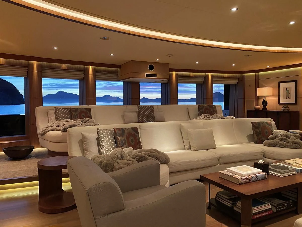 a living room with a large window aboard MAN OF STEEL Yacht for Charter