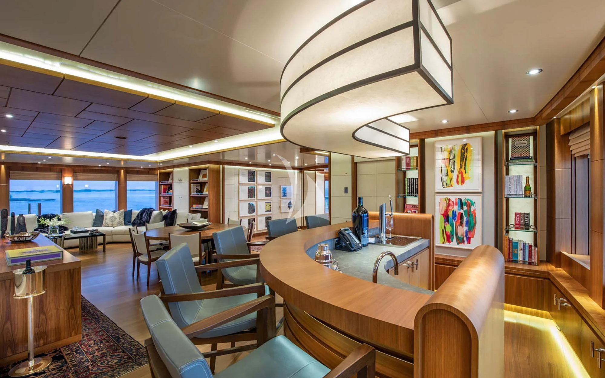 a room with tables and chairs aboard MAN OF STEEL Yacht for Charter