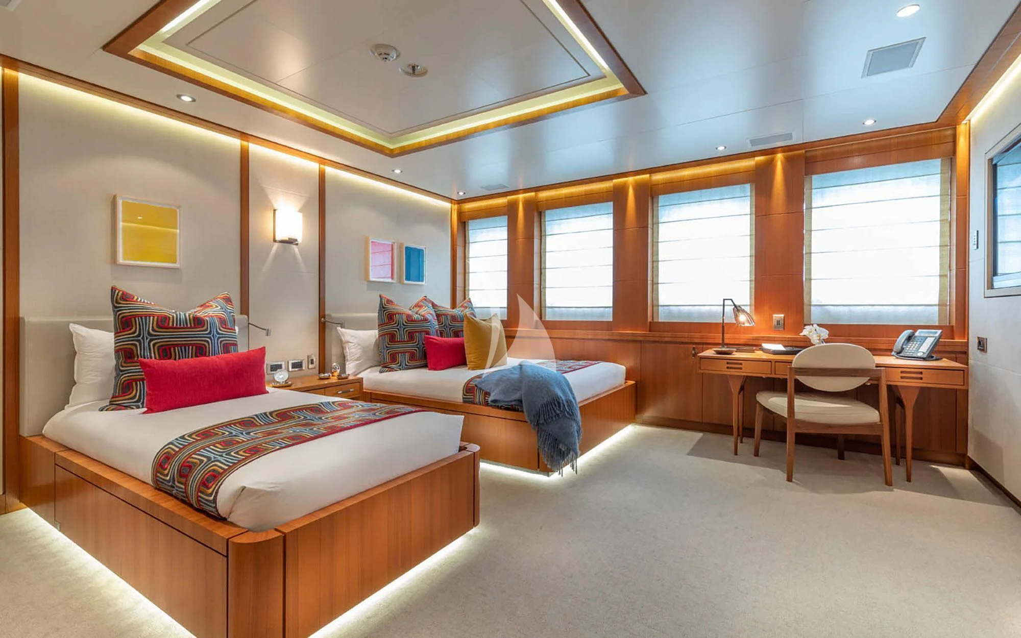 a room with a bed and a table aboard MAN OF STEEL Yacht for Charter