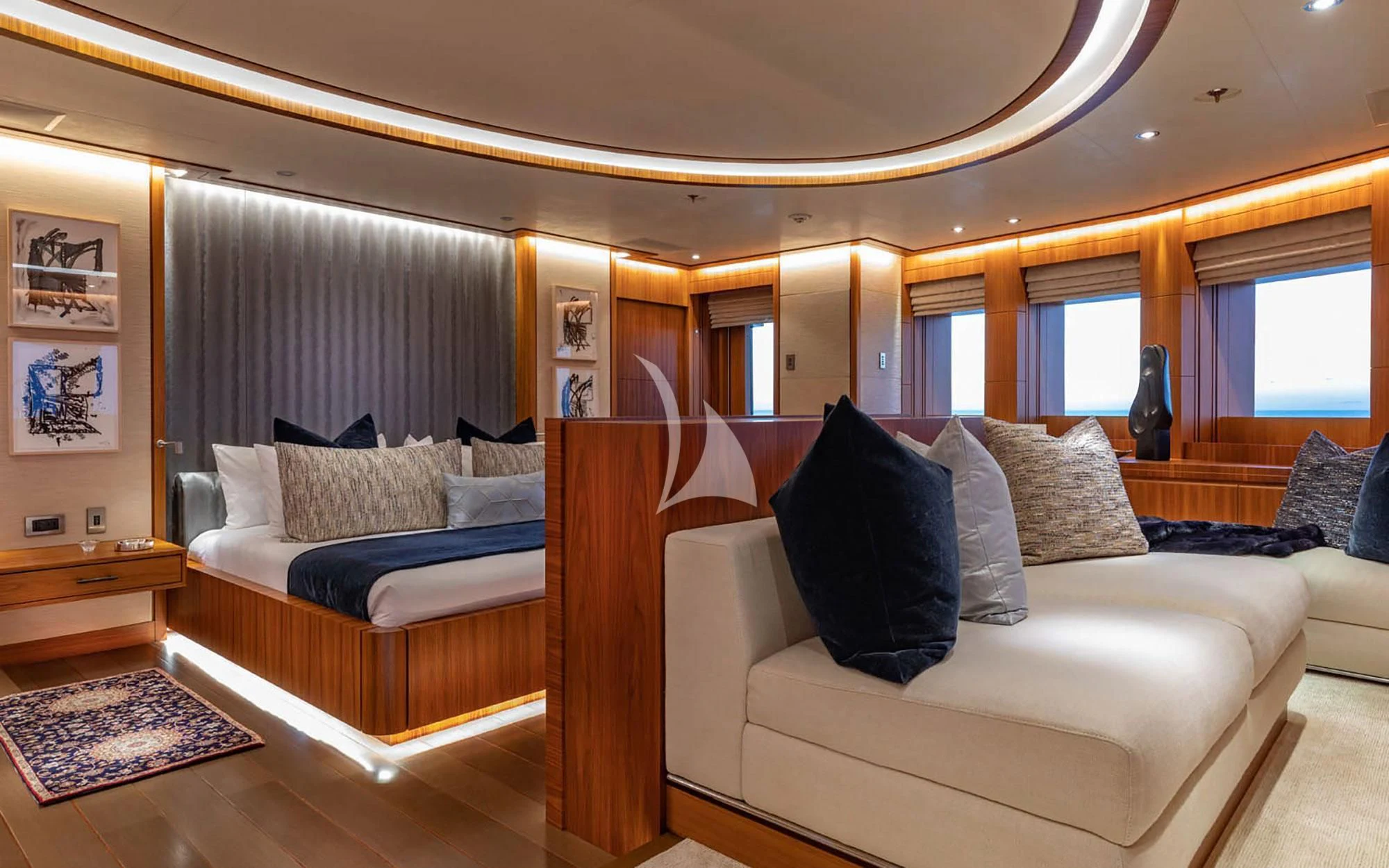 a room with a couch and a bed aboard MAN OF STEEL Yacht for Charter