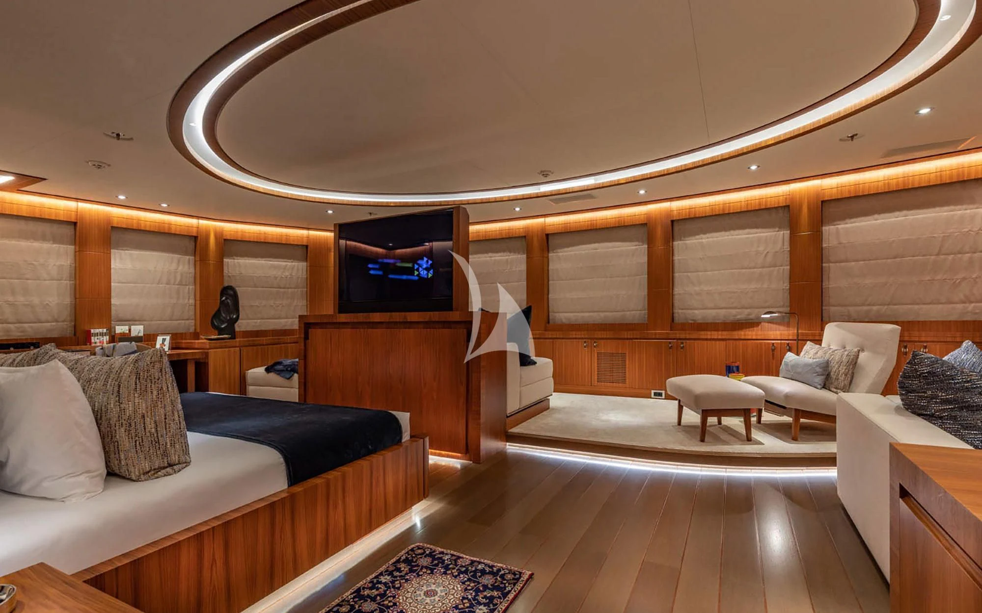 a room with a bed and a television aboard MAN OF STEEL Yacht for Charter