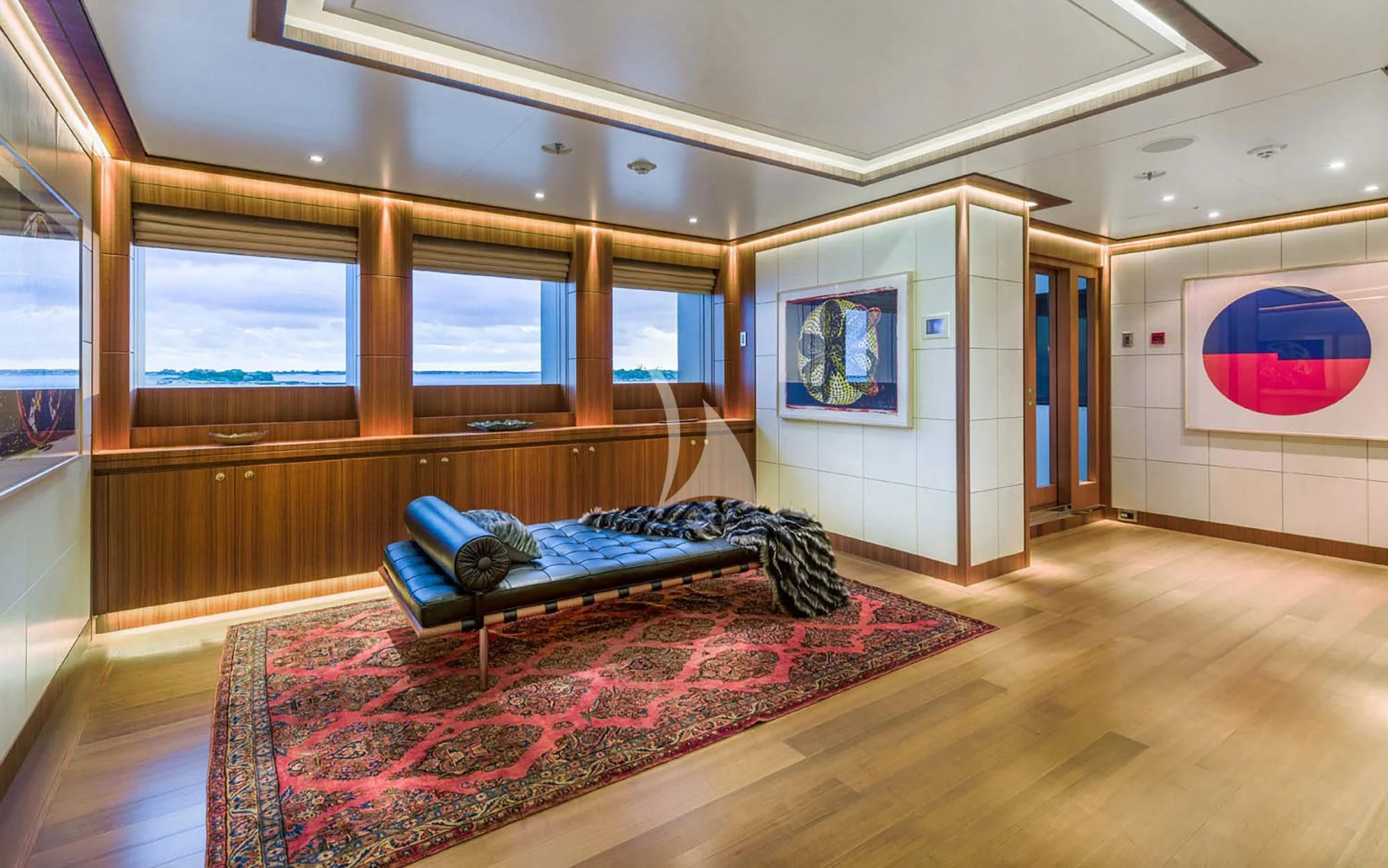 a bedroom with a bed and a bench aboard MAN OF STEEL Yacht for Charter
