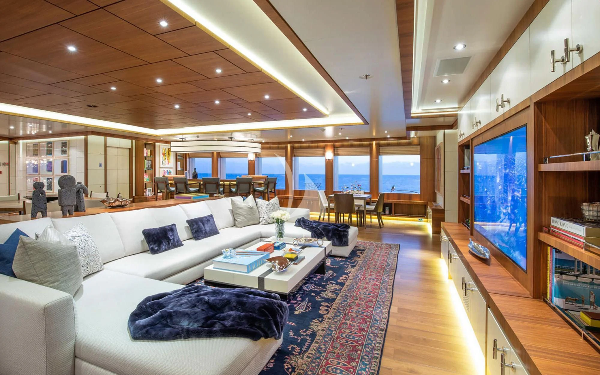 a living room with a large screen aboard MAN OF STEEL Yacht for Charter