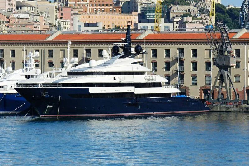 a large boat docked in a harbor aboard MAN OF STEEL Yacht for Charter