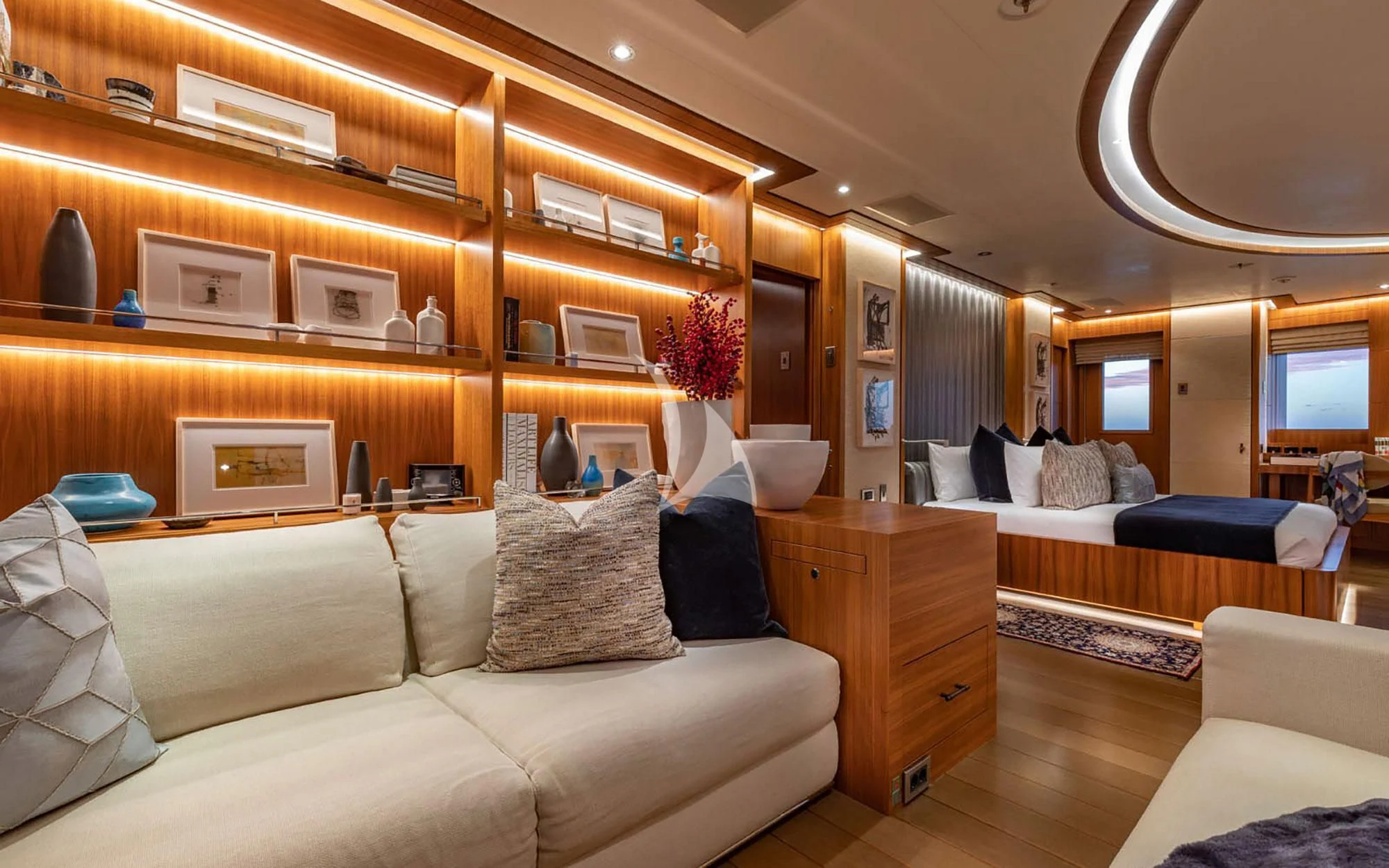 a living room with a large bookcase aboard MAN OF STEEL Yacht for Charter