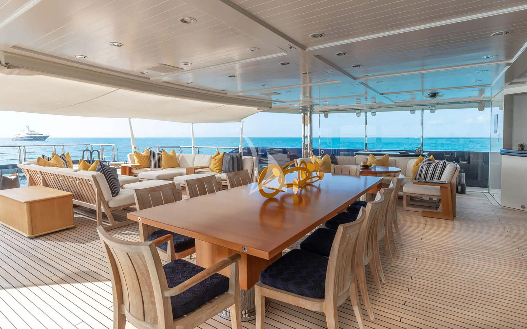 a large room with a table and chairs aboard MAN OF STEEL Yacht for Charter