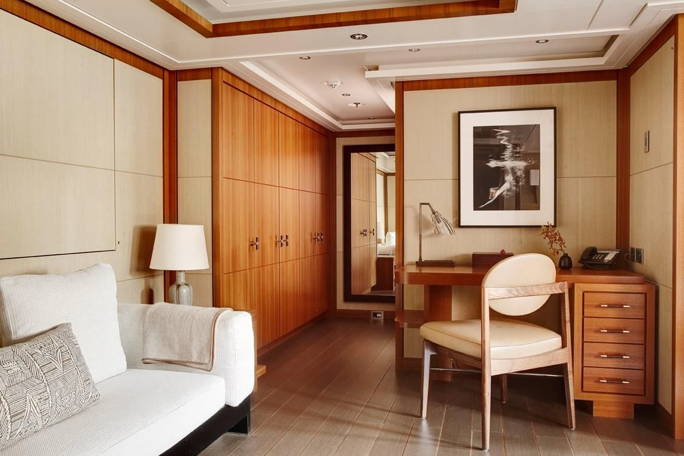 a room with a bed and a chair aboard MAN OF STEEL Yacht for Charter