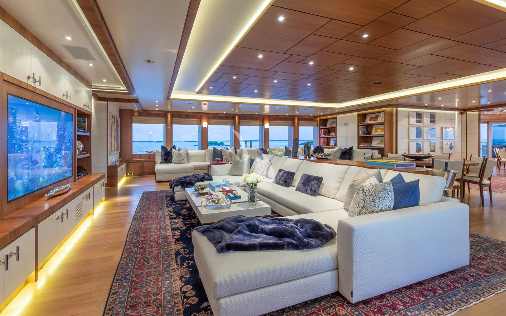 a living room with a large screen aboard MAN OF STEEL Yacht for Charter