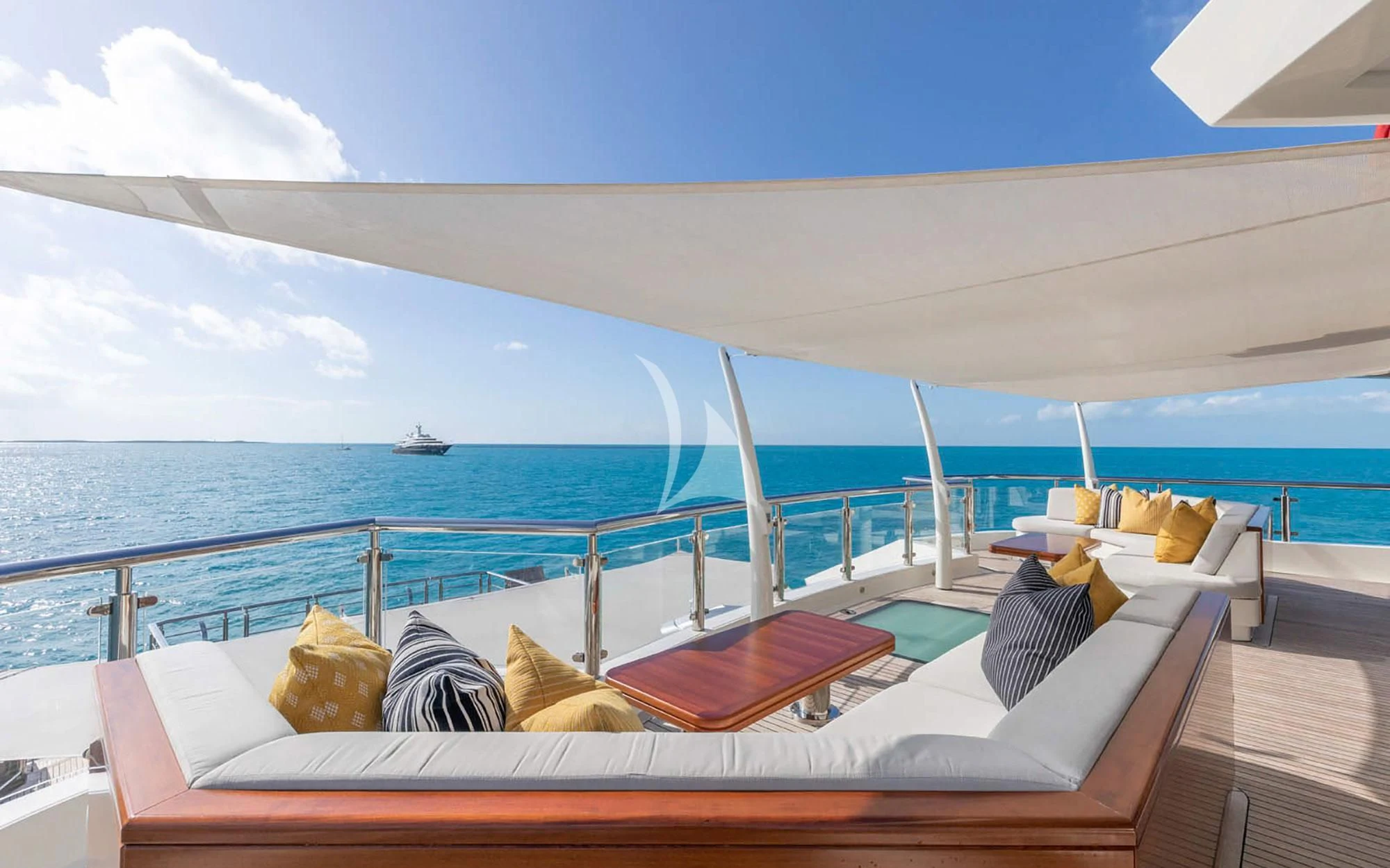 a large white boat on a body of water aboard MAN OF STEEL Yacht for Charter