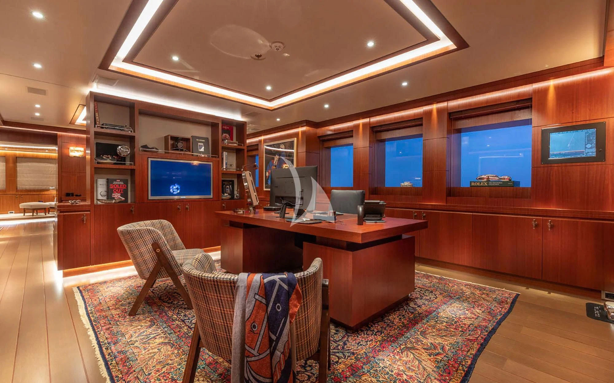 a room with a table and chairs aboard MAN OF STEEL Yacht for Charter