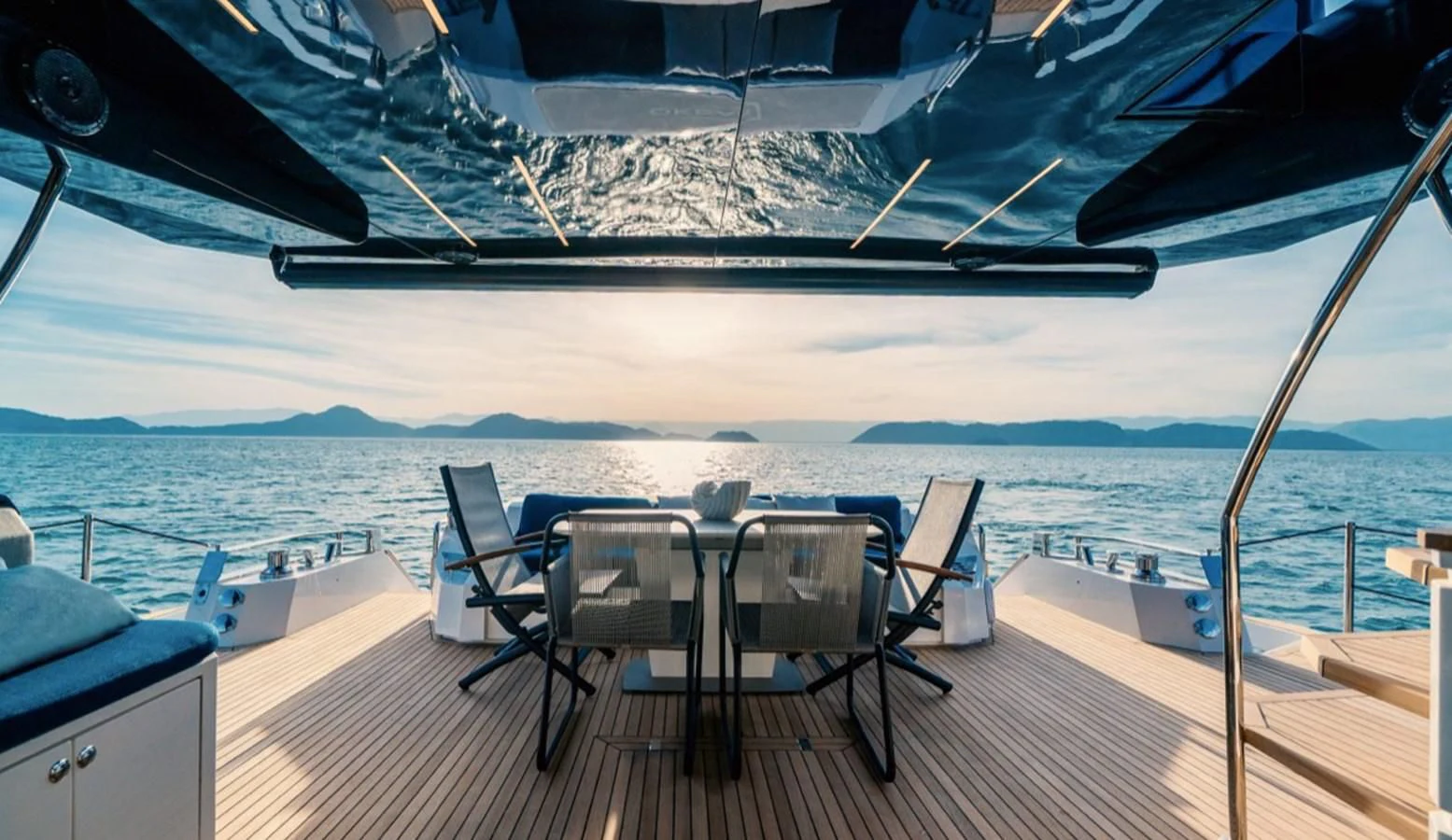 a deck with a table and chairs on it aboard OKEAN 80/01 Yacht for Sale