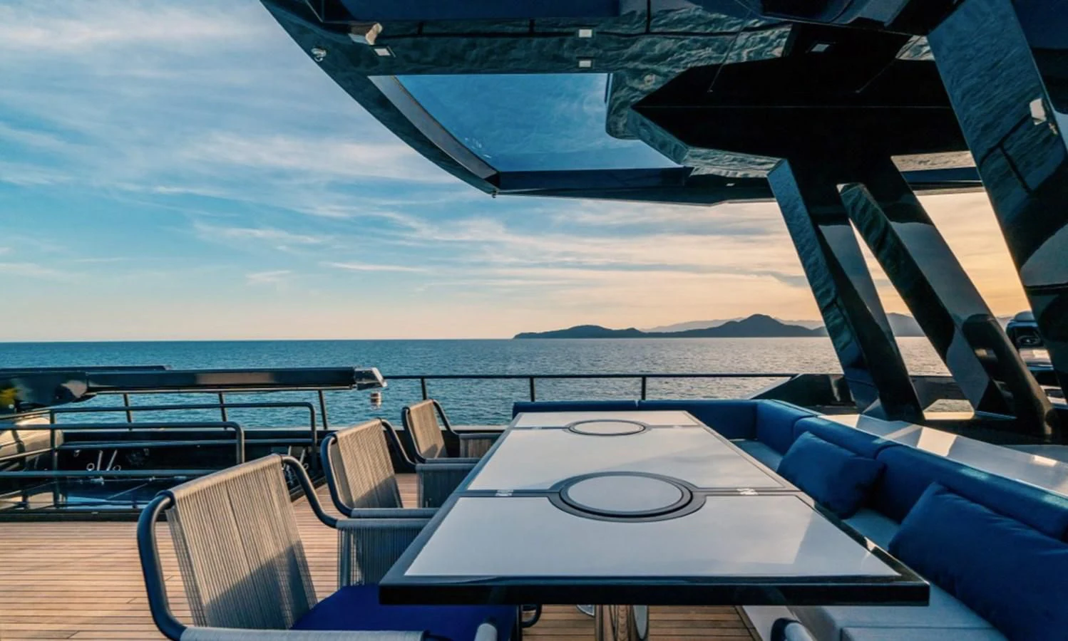 a table and chairs on a deck aboard OKEAN 80/01 Yacht for Sale