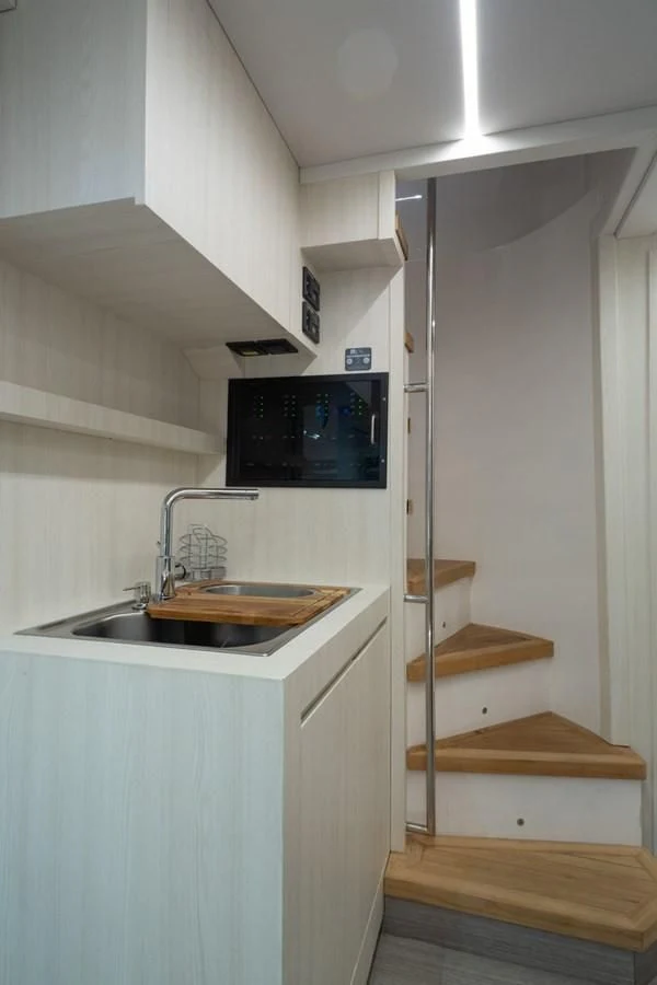 a small bathroom with a sink and a tv aboard OKEAN 80/01 Yacht for Sale
