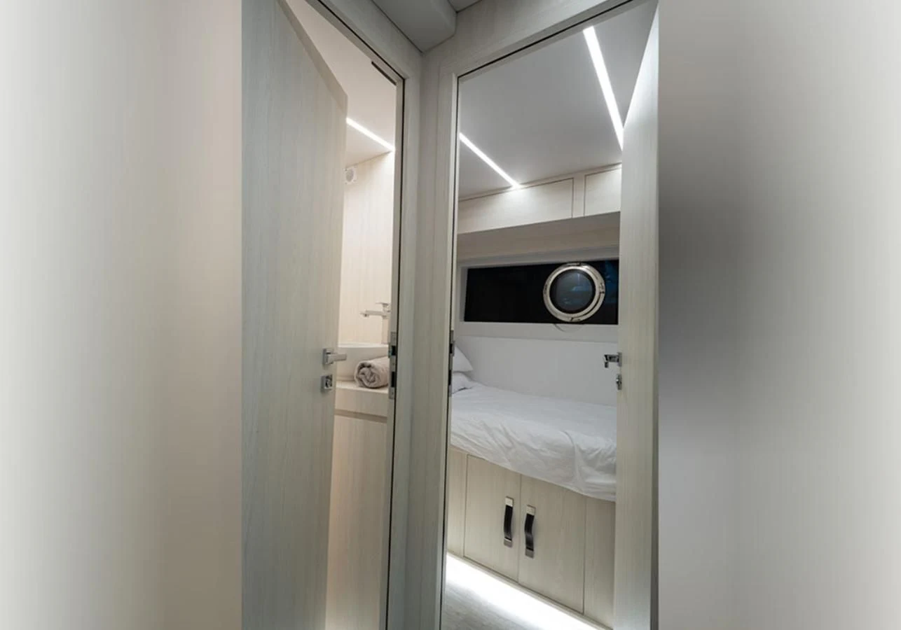 a room with a bed and a mirror aboard OKEAN 80/01 Yacht for Sale