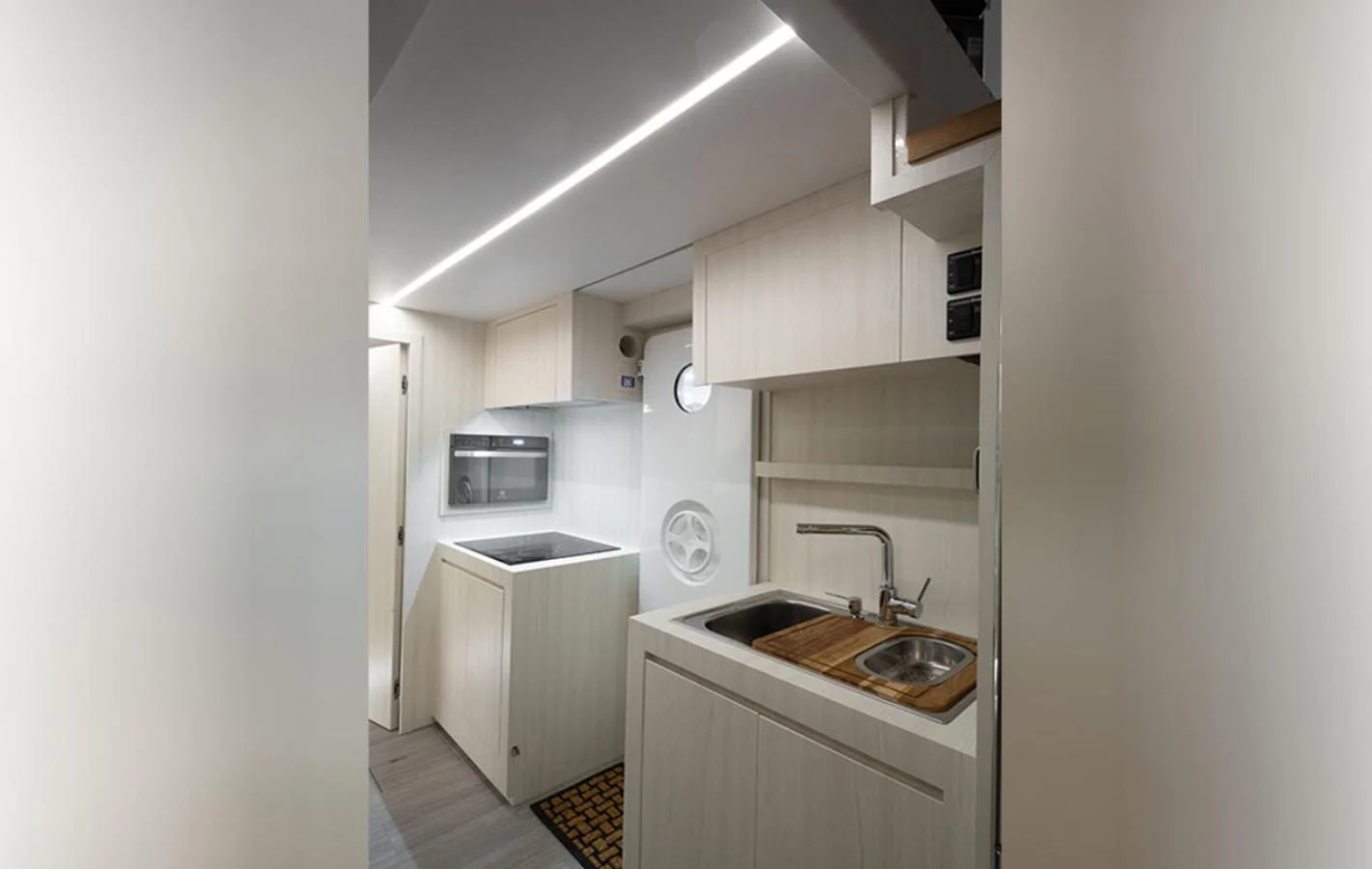 a kitchen with a sink and microwave aboard OKEAN 80/01 Yacht for Sale