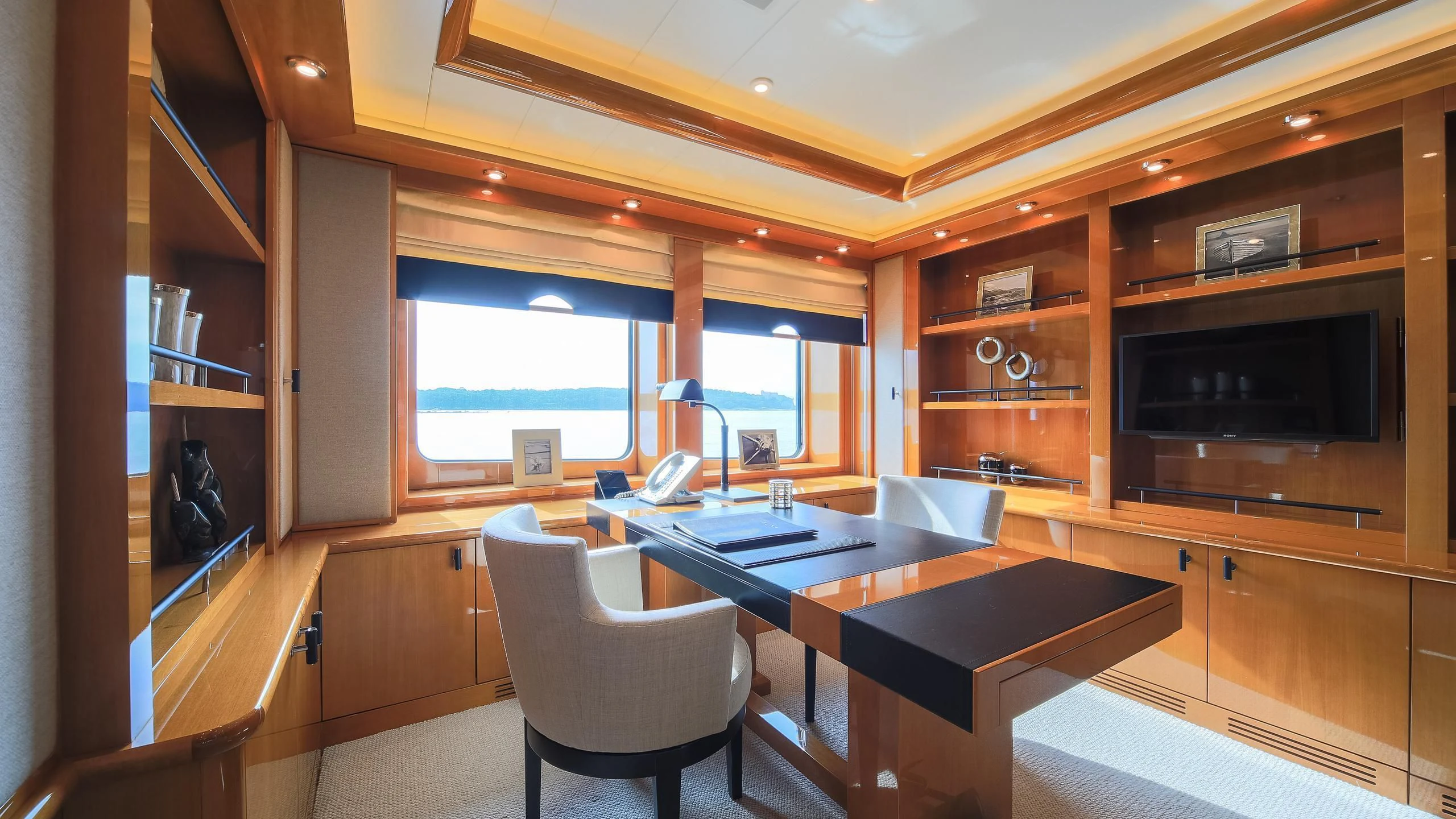 a room with a table and chairs aboard AHS Yacht for Sale