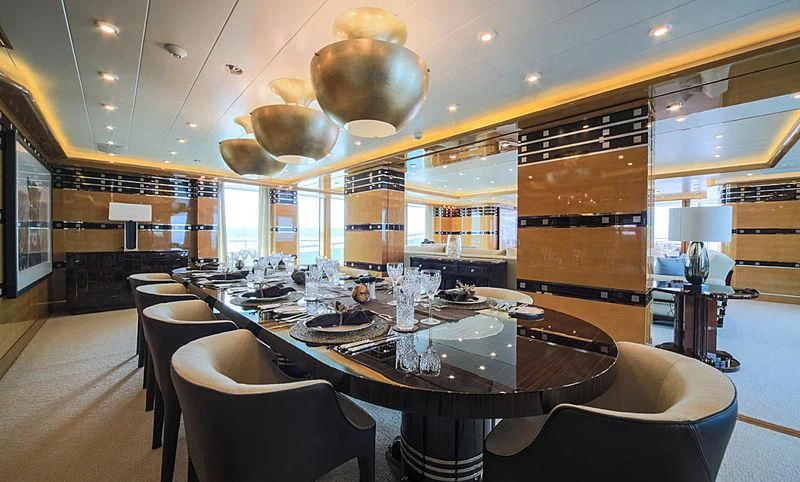a restaurant with a large table and chairs aboard AHS Yacht for Sale