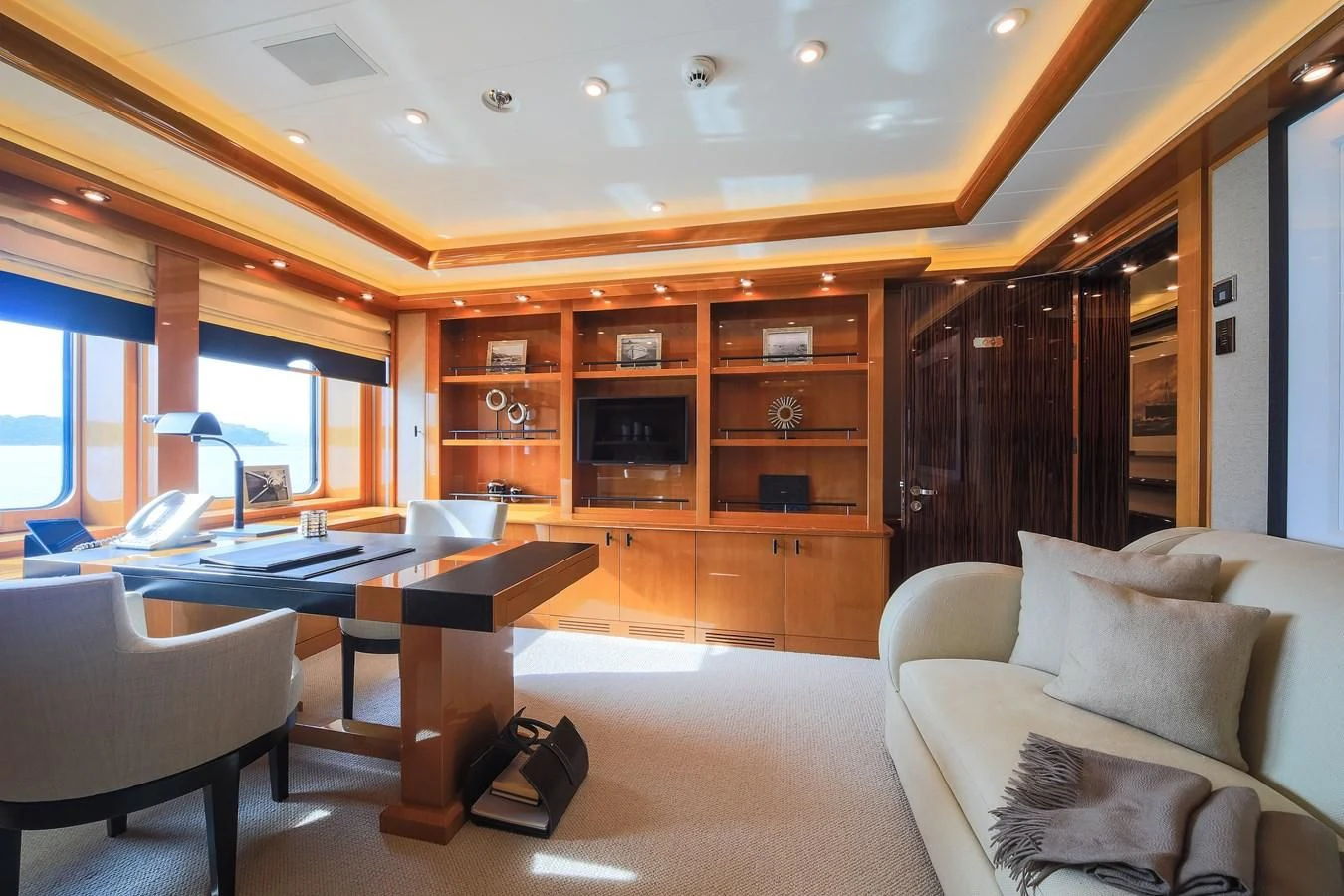 a living room with a couch and a tv aboard AHS Yacht for Sale